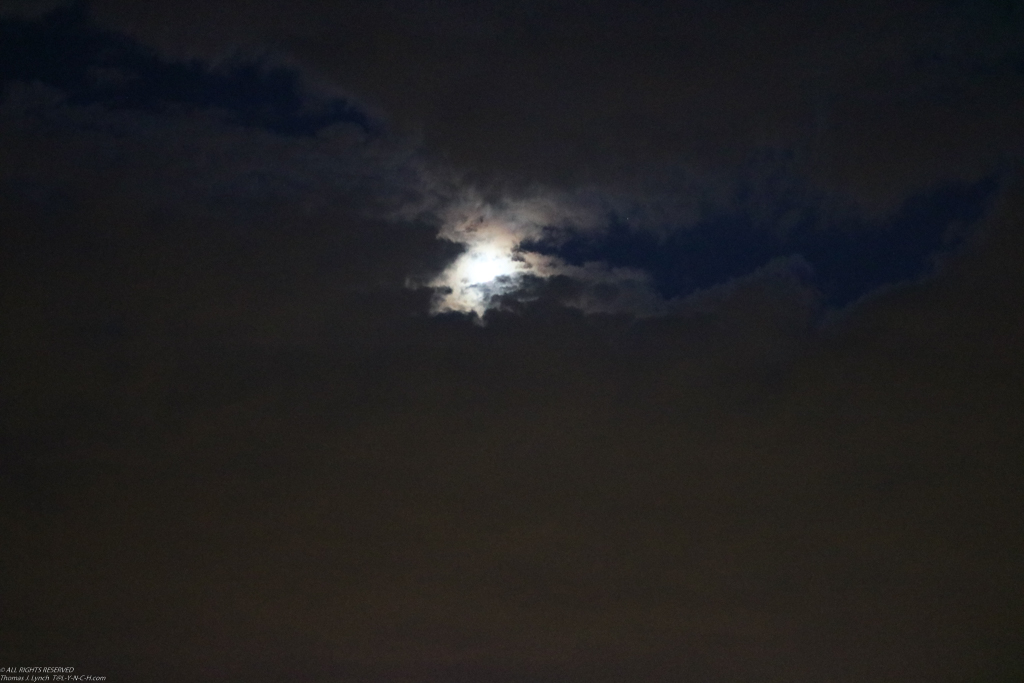 the moon peeking through the clouds at Cedar Beach  ~~  